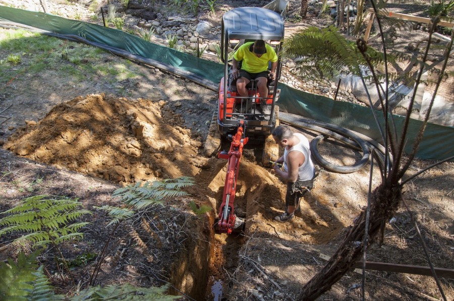One of the drains being dug by Stu and Garrick looks on.