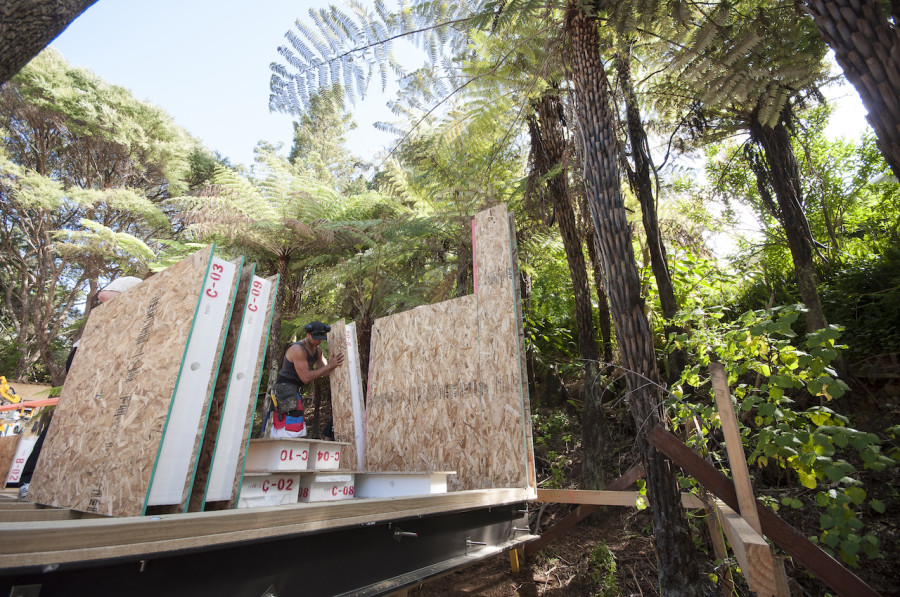 And then it began. Dan easily slides one of the first panels into place, forming the end wall of our bathroom.