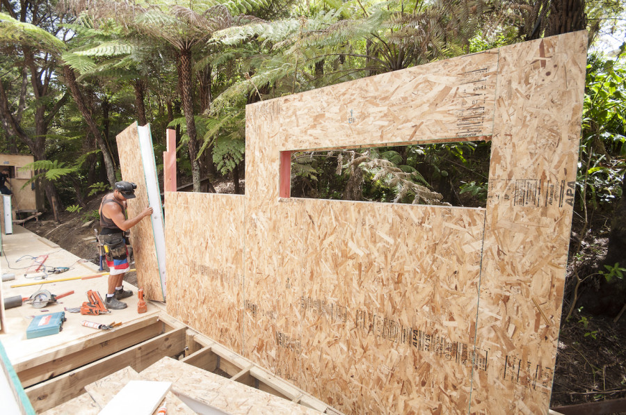 Such an efficient system. In under an hour we had a large section of wall up, forming the bathroom and laundry. You can see the beautiful slit windows offering glimpses into the bush. 