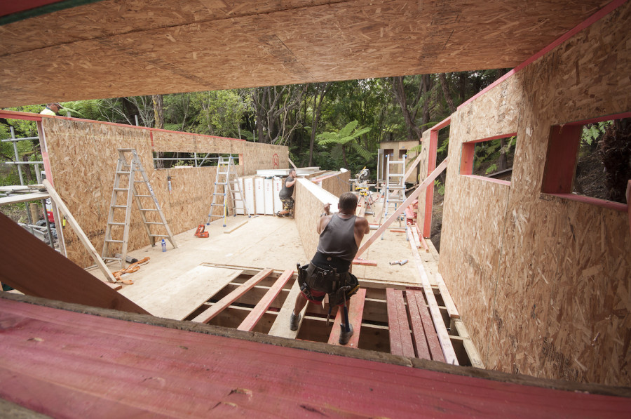 Dan and Garrick manoeuvring a panel around. Looking through the bathroom window and down to the end of the pod where our master bedroom will be.