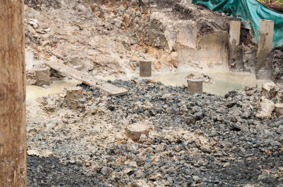 The area cleared out and filled with metal. All piles are now cut to height. These ones will support the concrete slab for our garage area.