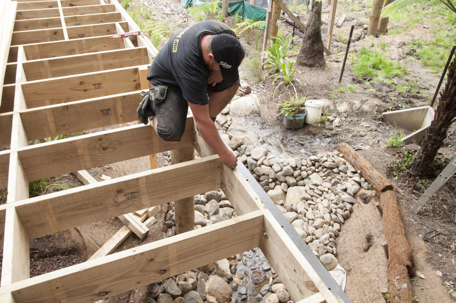 Garrick doing his thing - you can see how the house hovers right over the stream. This is about where our en suite will be. So cool!