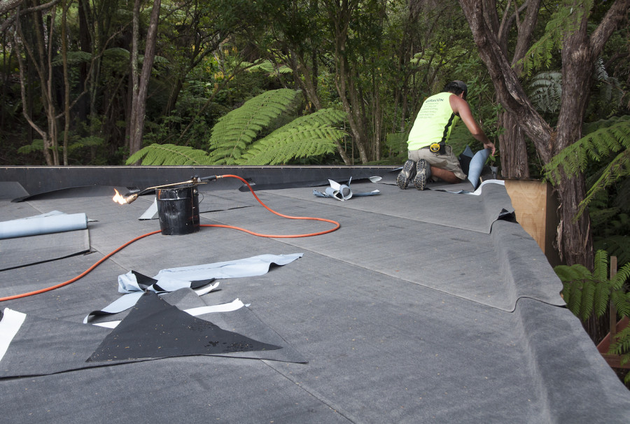 The base sheet is peel and stick layer, with the runs leading down the fall to the outlets.