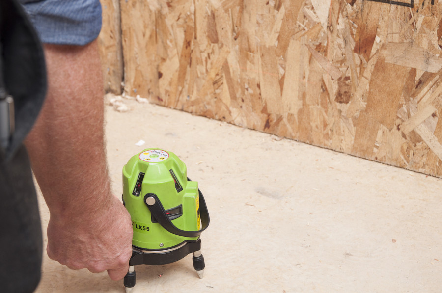 Mike setting up the line laser to assist with creating a perfect site measure. It also keeps the builders honest, with accuracy up to 3/4 of a mm in a space the size of ours.