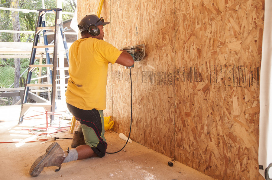 John, one of our builders cutting out the recess for our TV so the EAV boys can pre-wire it.