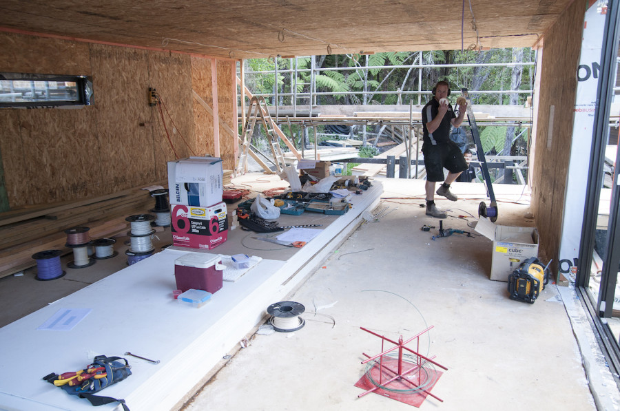 The SIPs panels require a little bit more work for the guys to wire them all up, but they come with pre-cut chases at plug and switch height, as well as vertical ones running the length of each panel. As a side note, the entire end wall in the living pod is a Eurostaker door from Fletcher Window & Door Systems. It will literally slide completely away, opening the living area out onto a large deck and the bush beyond. Yummo!