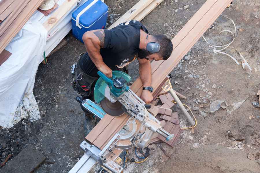Paul cutting a mitre on the end of a board - it's a time consuming and perfectionist job cladding the house.