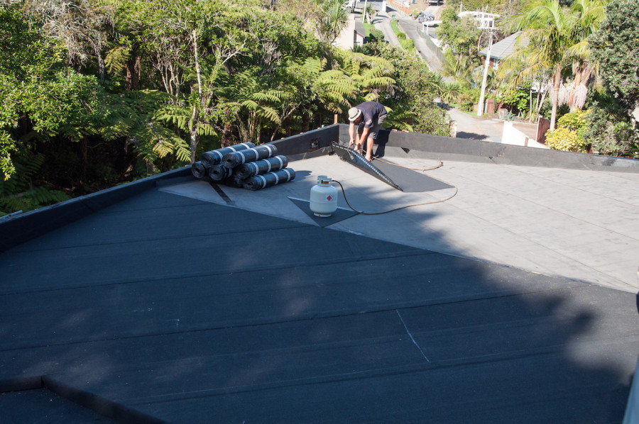 Base sheet down and Lyndon from Terracon torching on the cap-sheet