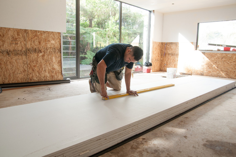Builder John measuring up plasterboard in the living pod. You can see the large window behind him which is where our dining table will eventually sit.